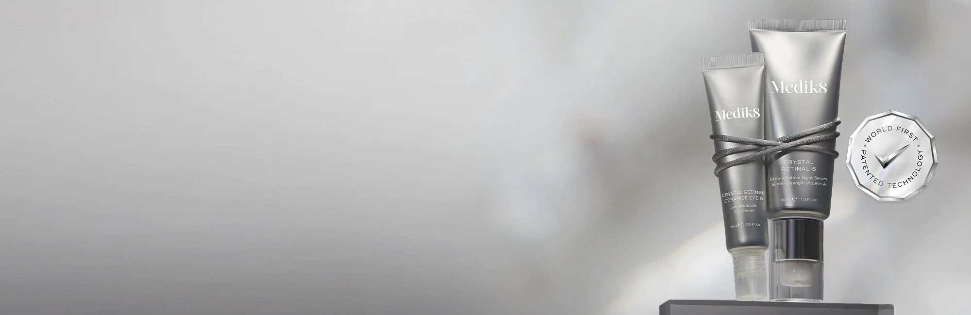 A pair of eyeliner pencils on a stand with a silver award.